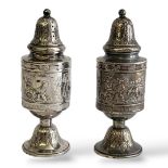 A PAIR OF EARLY 20TH CENTURY CONTINENTAL SILVER PEPPERETTES Having an embossed figural country