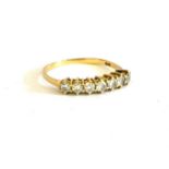 AN 18CT GOLD AND DIAMOND HALF ETERNITY RING Having row of eight round cut diamonds. (size N,