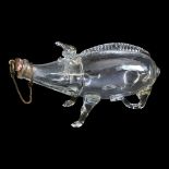 A 19TH CENTURY GLASS PIG FORM LIQUOR DECANTER Having raised decoration and cork stopper. (approx