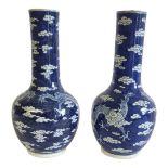 A PAIR OF 19TH CENTURY CHINESE BLUE AND WHITE PORCELAIN DRAGON VASES Opposing four claw dragons