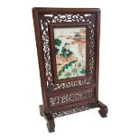 A CHINESE FAMILLE ROSE PORCELAIN AND HARDWOOD TABLE SCREEN Seated fisherman wearing period attire,