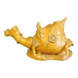 A 19TH CENTURY SALT GLAZED POTTERY CAMEL FORM WINE CARAFE Recumbent pose with applied decoration. (