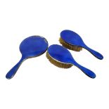 A PAIR OF EARLY 20TH CENTURY SILVER AND ENAMEL CLOTHES BRUSHES Blue guillochè enamel, hallmarked
