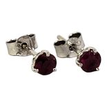 A PAIR OF 18CT WHITE GOLD AND RUBY STUD EARRINGS Each set with a round cut ruby. (approx total