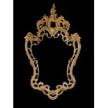 A LATE 20TH CENTURY LOUIS XV ROCOCO STYLE HIGHLY ORNAMENTAL GILDED METAL WALL MIRROR Surmounted by