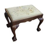 AN EARLY 20TH CENTURY RECTANGULAR ELM FOOTSTOOL With hand embroidered cushion inset, on four