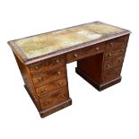 A VICTORIAN MAHOGANY DESK With green tooled leather surface above, an arrangement of nine drawers