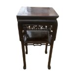 A 19TH CENTURY CHINESE ROSEWOOD TABLE The square top above a floral pierced apron and under tier, on