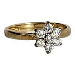 A VINTAGE 18CT GOLD AND DIAMOND CLUSTER RING The arrangement of round cut stones on a plain mount,