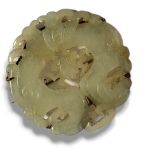 A CHINESE QING DYNASTY JADE TWO DRAGON CARVED MILKY CELADON JADE BROOCH Centrally carved with an