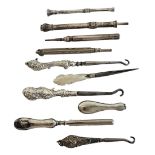 A COLLECTION OF THREE SILVER BUTTON HOOKS Elaborate handles with steel blades, together with a