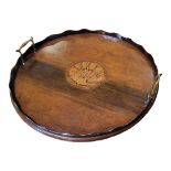 A 19TH CENTURY MAHOGANY BUTLER’S TRAY Having two brass handles, piecrust gallery edge and inlaid