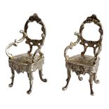 A PAIR OF EARLY 20TH CENTURY CONTINENTAL SILVER MINIATURE CHAIRS Dutch form with scrolled arm
