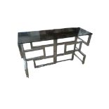 A VINTAGE CHROME CONSOLE TABLE With smoked glass top on articulated base. (126cm x 47cm x 72cm)