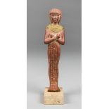 AN EGYPTIAN USHABTI FIGURE UPON A STONE BASE. (h 24.5cm). AF. Repair/break above feet with movement.