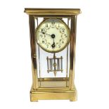 A VICTORIAN BRASS AND FOUR GLASS CLOCK With enamelled dial and mercury pendulum. (11cm x 9cm x 21cm)