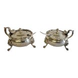 A MATCHED PAIR OF SILVER AND BLUE GLASS MUSTARD POTS Single handle with gadrooned border, lion