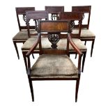 A SET OF SIX EARLY 19TH CENTURY CONTINENTAL MAHOGANY DINING CHAIRS Including one carver, with