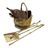A VINTAGE BRASS FIRESIDE COMPANION SET Comprising a set of tongs, poker and shovel fire irons,