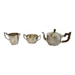 WILLIAM COOMBS AND SONS, AN ART DECO SILVER CIRCULAR TEA SERVICE With carved wooden finial and