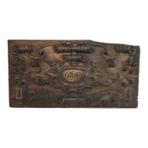 AN ANTIQUE ENGLISH OAK PANEL CARVED IN DEEP RELIEF WITH SYMMETRICAL SCROLLING FOLIAGE Centrally