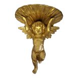 A CONTINENTAL 20TH CENTURY ROCOCO STYLE GILTWOOD WALL BRACKET MODELLED AS A CHERUB HOLDING A