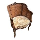 A 19TH CENTURY FRENCH WALNUT TUB ARMCHAIR Double caned, on carved cabriole legs, with loose cushion.