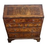 AN 18TH CENTURY WALNUT BUREAU The fall front enclosing a fitted interior above an arrangement of
