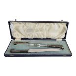 A VINTAGE SILVER HANDLED CARVING SET Each having a pistol grip handle hallmarked Sheffield, 1972, in