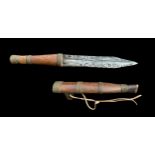 ‘MURDER WEAPON’, AN ANTIQUE SHONA DAGGER AND SCABBARD. Provenance by repute: A murder weapon from