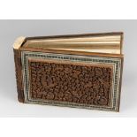 A LATE 19TH CENTURY ANGLO INDIAN HIGHLY CARVED MOSAIC PHOTO ALBUM. Sandalwood with raised reliefs,