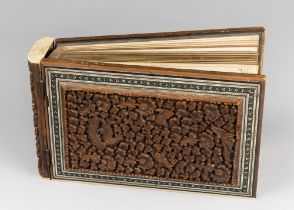 A LATE 19TH CENTURY ANGLO INDIAN HIGHLY CARVED MOSAIC PHOTO ALBUM. Sandalwood with raised reliefs,