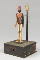 AN EARLY 20TH CENTURY NATIONAL MICROPHONE DANCING MAN TOY. The base of the toy shows instructions of
