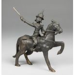 AN EARLY 20TH CENTURY BURMESE BRONZE STATUE OF A WARRIOR ON HORSEBACK. (h 21cm x w 20cm x d 7.5cm)