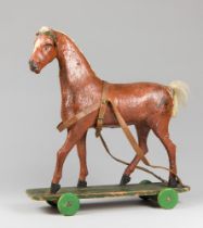 A LATE 19TH CENTURY ENGLISH OVERSIZED PAPIER-MÂCHÉ PULL ALONG TOY HORSE. A handmade example with