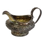 A KING WILLIAM IV SILVER CREAM JUG Having a single handle of squat form with embossed floral