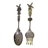 A PAIR OF VINTAGE DUTCH SILVER SALAD SERVERS Having articulated windmill form finials and embossed