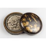 AN ANTIUQE JAPANESE BLACK AND GOLD LACQUER DOMED CIRCULAR KAGAMIBAKO (MIRROR BOX) AND COVER WITH A