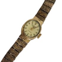 ROTARY, A VINTAGE 9CT GOLD LADIES’ WRISTWATCH Oval form dial with textured 9ct gold bracelet strap