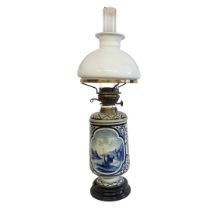 AN EDWARDIAN DUTCH DELFT BRASS MOUNTED OIL LAMP Cylindrical shade, central body blue and white