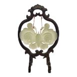 A CHINESE CELADON JADE PENDANT MODELLED AS A BUTTERFLY With lustre iridescent glazes, raised on an