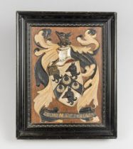 A 19TH CENTURY FRAMED COAT OF ARMS. A highly decorative example of a family shield. Gesso on wood