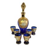 A 1960’S VENETIAN MURANO JEWELLED BLUE GLAZED GLASS DECANTER AND STOPPER Along with six matching