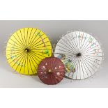 TWO BURMESE SILK MYANMAR UMBRELLAS AND A JAPANESE BAMBOO PAPER UMBRELLA. Largest open (h 64cm x w