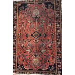 A MID CENTURY PERSIAN MEHRABAN RUG With central flora field contained in running borders, on a