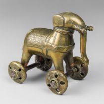AN EARLY 20TH CENTURY INDIAN BRASS ELEPHANT TEMPLE TOY ON WHEELS. (h 13cm x w 14cm x d 9.5cm).