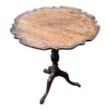 AN EARLY 20TH CENTURY MAHOGANY OCCASIONAL TABLE With piecrust tilt top, on a single column with