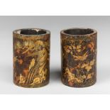 A PAIR OF 19TH CENTURY CHINESE LACQUER BAMBOO POTS, WITH APPLIED GILT GOLD SCENES. Probably scroll
