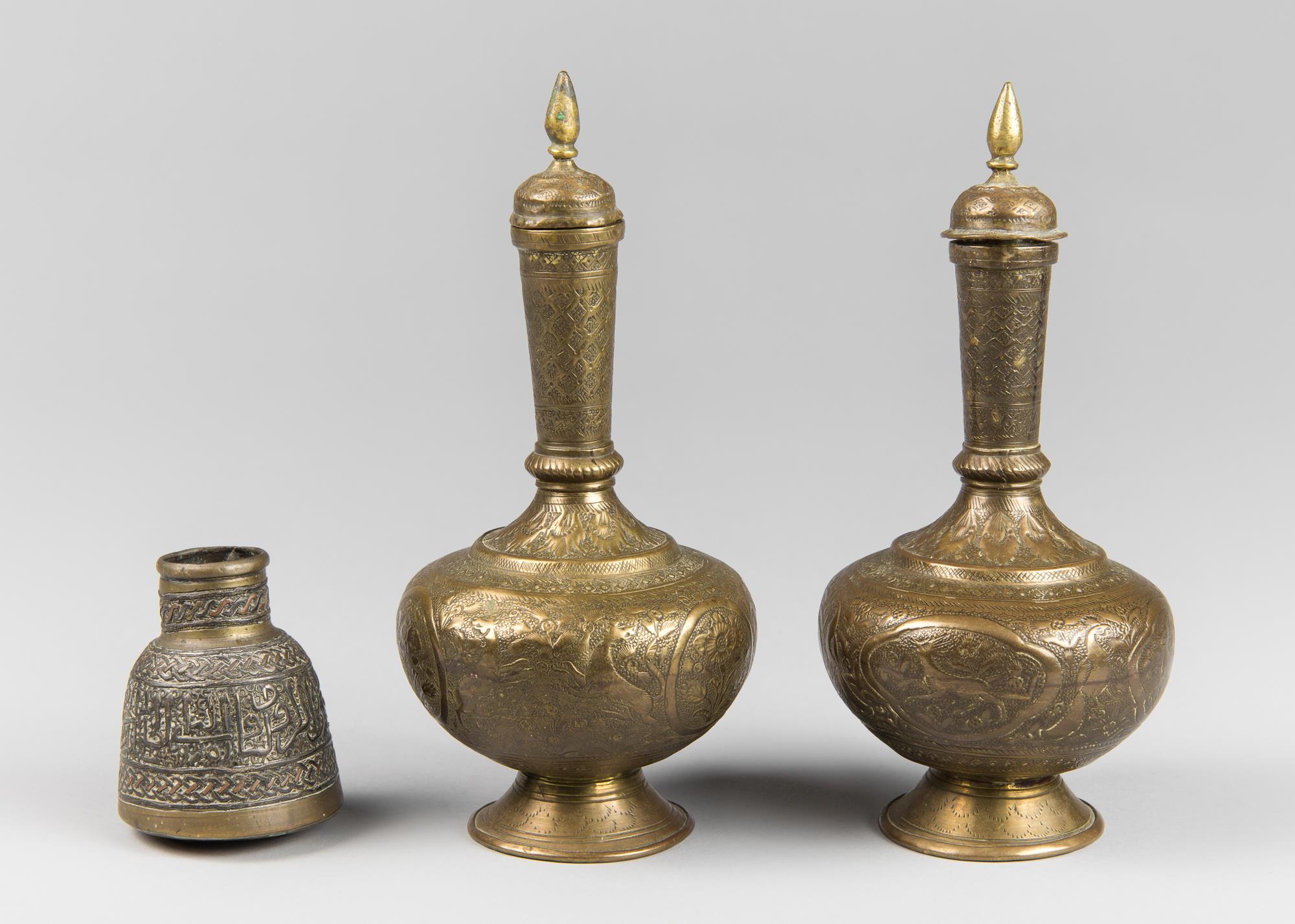 A PAIR OF ANTIQUE INDIAN ENGRAVED BRASS LIDDED SURAHI WATER VESSELS AND AN ANTIQUE PERSIAN