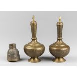 A PAIR OF ANTIQUE INDIAN ENGRAVED BRASS LIDDED SURAHI WATER VESSELS AND AN ANTIQUE PERSIAN